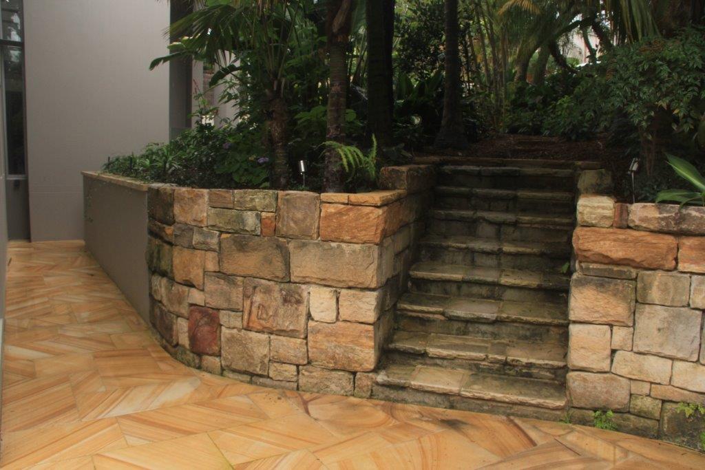 Sandstone retaining wall, stairs and pavers