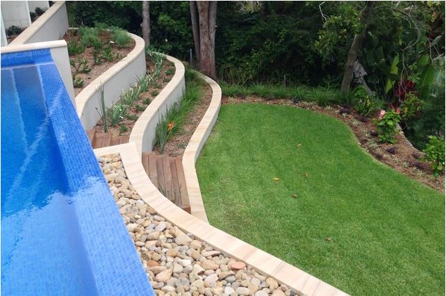 Wet edge swimming pool tiered landscaping